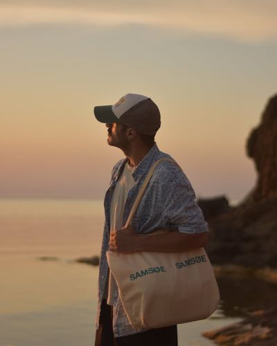 Silhouette of a man standing calmly, looking out, conveying a sense of peace.